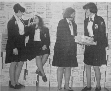 Junior Year Academy Student Council: Jane Driscoll Treasurer, Marcia DuPage VP, Maureen Kelly Secretary, and Kathy McQuellon President discuss the Chocolate Drive - 36,000 bars of the Worlds Finest Chocolate